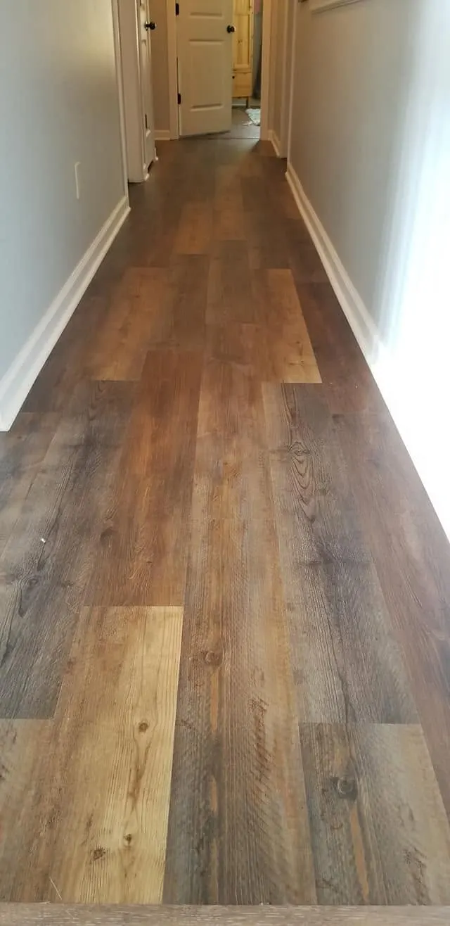 Rich dark wood-look luxury vinyl plank flooring across an open room