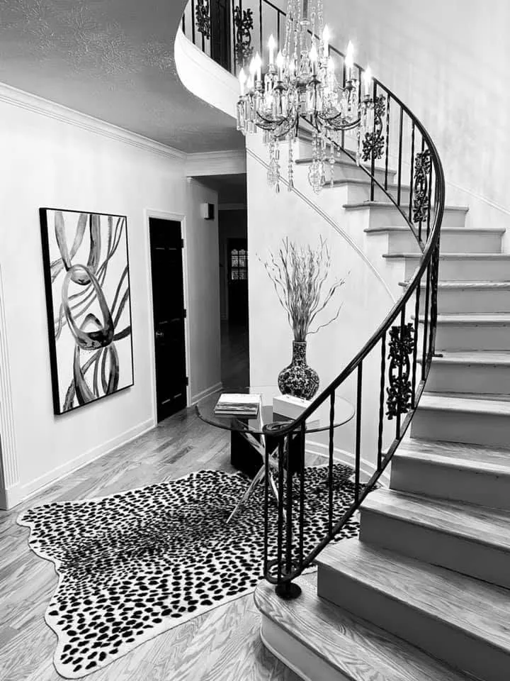 Elegant foyer with a curved staircase and wood flooring