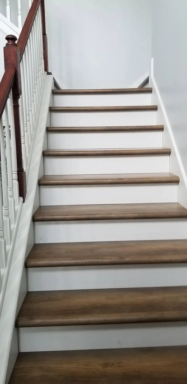 Wood-look luxury vinyl stair treads with crisp white risers