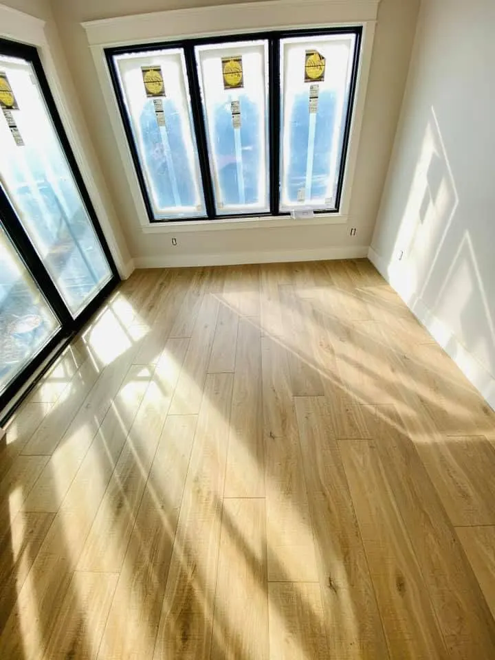 Sunroom with light wood-look plank flooring and floor-to-ceiling windows