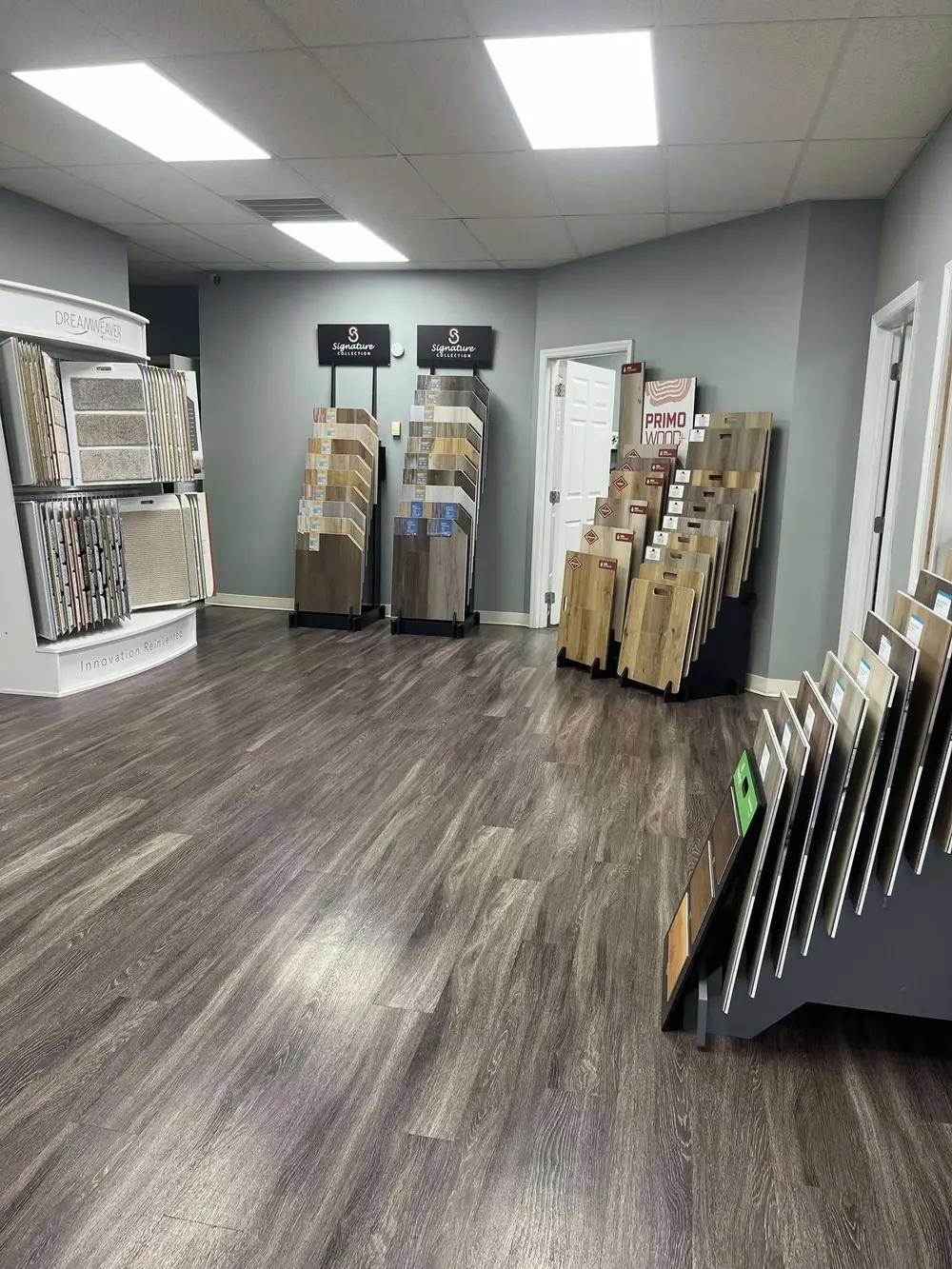 Dreamweaver carpet display and racks of luxury vinyl plank samples