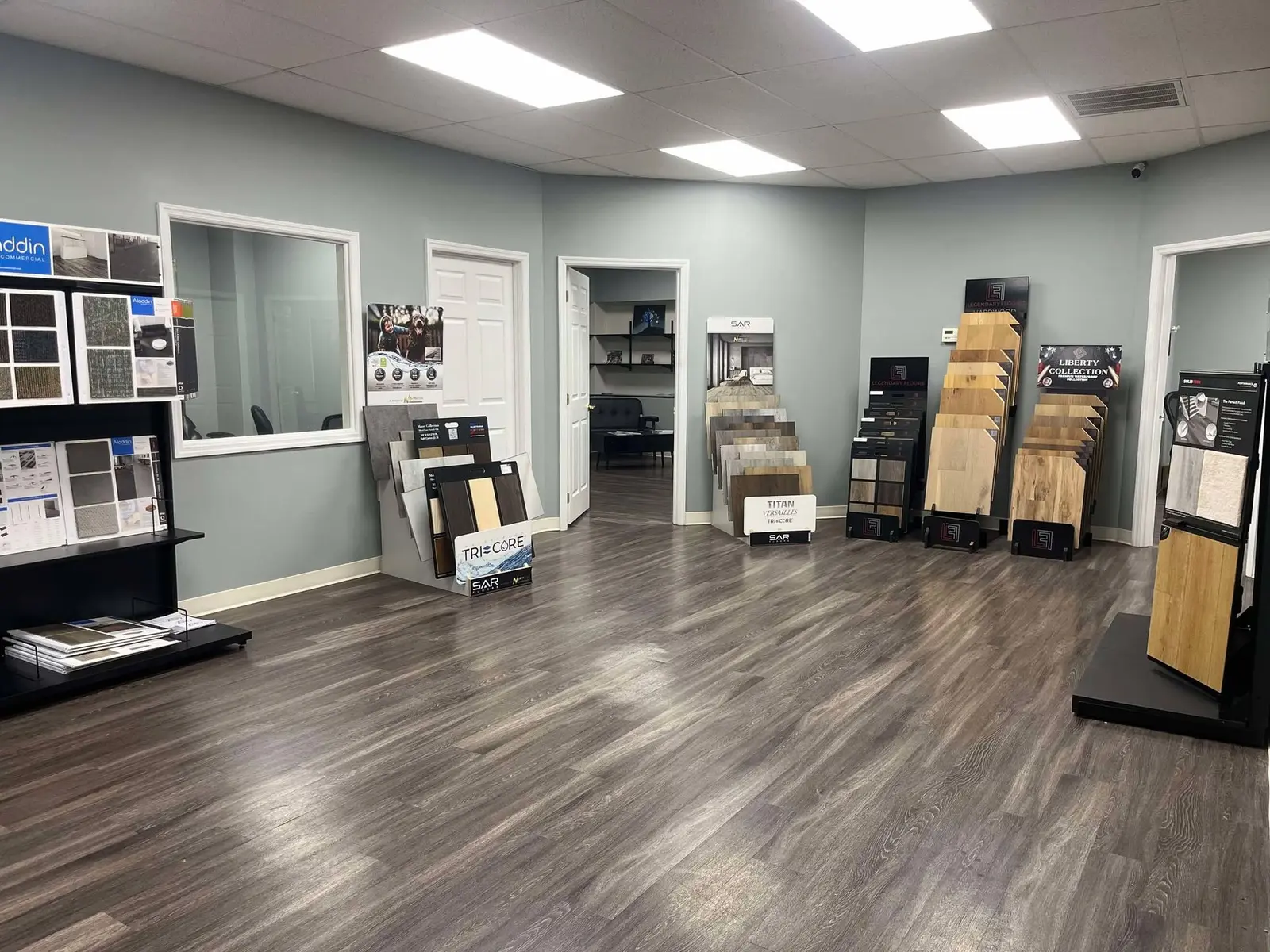 Inside the Brothers Flooring showroom in Knoxville — racks of hardwood, LVP, and waterproof flooring samples